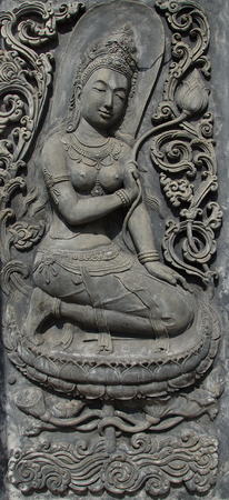 Deva sculpture on cement wallの写真素材