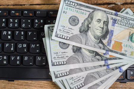 Stack of one hundred dollar bills  on keyboardの写真素材
