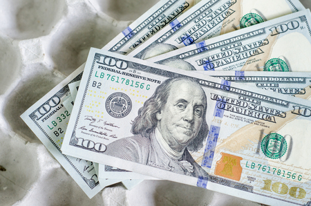 Stack of one hundred dollar bills  on tray egg の写真素材