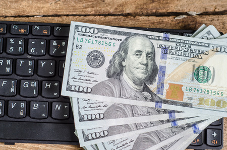 Stack of one hundred dollar bills  on keyboardの写真素材