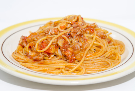 Spaghetti with pork on plate isolated on white backgroundの写真素材