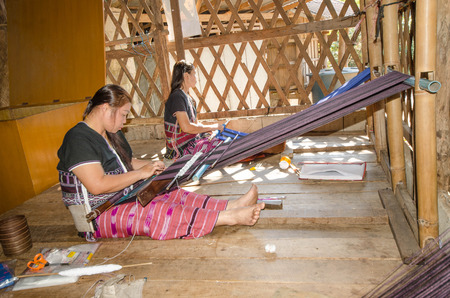 BAN NAI SOI, MAE HONG SON PROVINCE, THAILAND - December 14: Karen tribe unidentified woman working at loom in Ban Nai Soi, Thailand, December 14, 2014.のeditorial素材