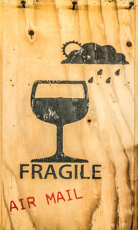 Glass icon of fragile item spray on brown plywood texの写真素材