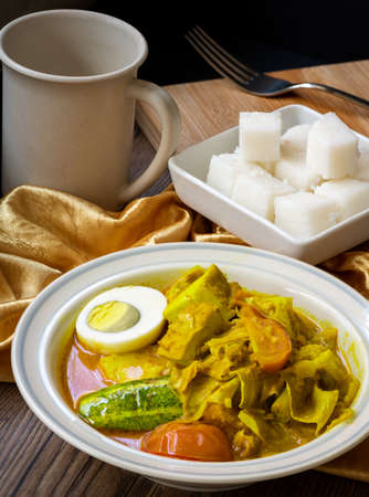 Lontong, an Indonesian dish with compressed rice cake, served with coconut-based dishes and vegetables, common in Indonesia, Malaysia and Singaporeの写真素材