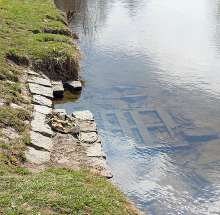 riverside and wooden planks in the riverbedの写真素材