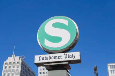 BERLIN, GERMANY - AUGUST 25, 2016: S-Bahn Urban Railway Station Sign Potsdamer Platz With Blurry Skyscrapers In The Backgroundのeditorial素材