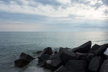 Black Rocks In The Sea At Hiddensee Island Beach Before Sunsetの写真素材