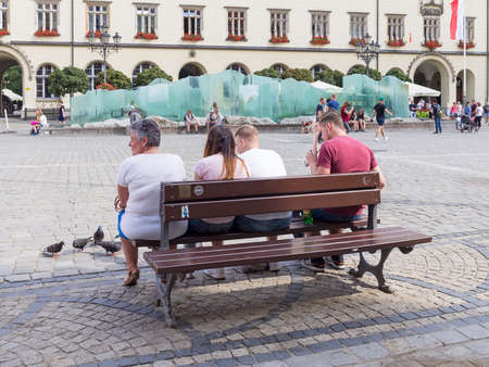WROCLAW, POLAND - AUGUST 14, 2017: Tourists On A Bench At Rynek Market Square In Wroclawのeditorial素材
