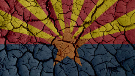Political Crisis Or Environmental Concept: Mud Cracks With Arizona Flagの写真素材