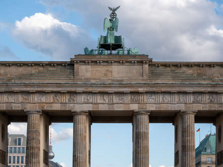 The Quadriga of Brandenburg Gate Against A Blue Cloudy Sky With TV Tower In The Background In Berlin, Germanyの写真素材