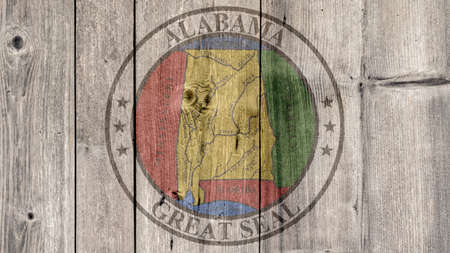 USA Politics News Concept: US State Alabama Seal Wooden Fence Backgroundの写真素材