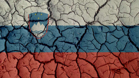 Political Crisis Or Environmental Concept: Mud Cracks With Slovenia Flagの写真素材