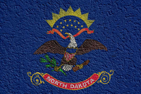 US State Politics Or Business Concept: North Dakota Flag Wall With Plaster, Background Textureの写真素材