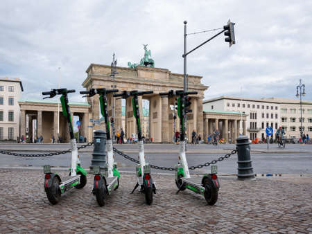 BERLIN, GERMANY - JULY 8, 2019: Motorized Electric Scooters At Brandenburg Gate In Berlin, Germany...
