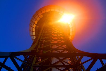 Sun glaring off a sky view tower.