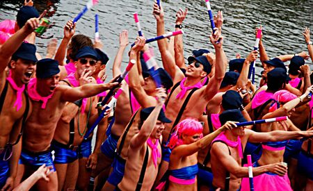 Amsterdam, the Netherlands-August 7, 2010-Young men dancing at canal parade of Gay Pride 2010のeditorial素材