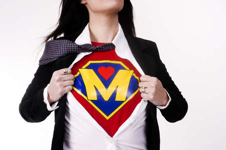 Woman wears a superhero style t-shirt under her business suitの写真素材