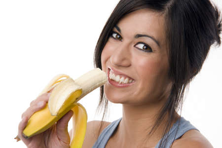 Beautiful Brunette holds a Bananaの写真素材