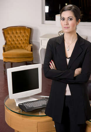 A Business Woman standing in front of her deskの写真素材