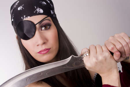 A beautiful pirate shows you her bladeの写真素材