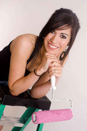 A beautiful brunette home maker prepares to paint a room in her homeの写真素材