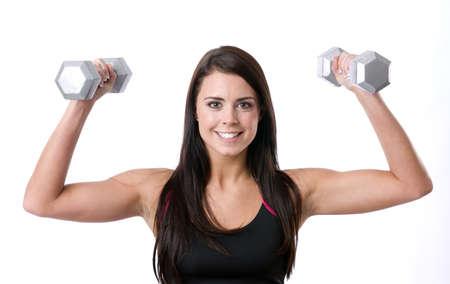 Sexy fitness instructor working out with free weights の写真素材