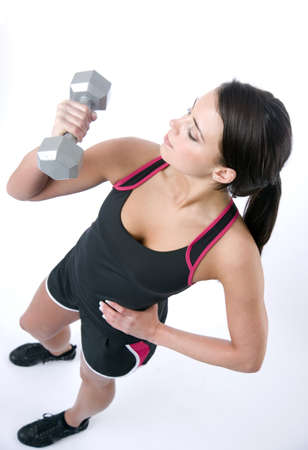 Sexy fitness instructor working out with free weightsの写真素材