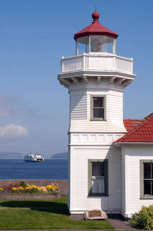 A ferry crosses the Puget Sound behind the Lighthouseのeditorial素材