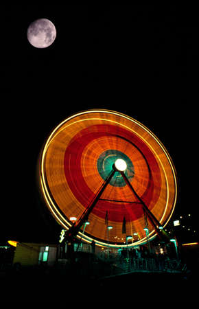 A fair ride at night with full moonの写真素材