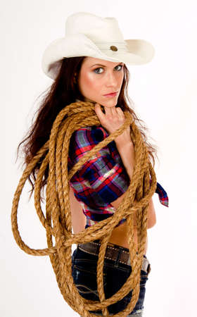A hero cowgirl in white hat holds her ropeの写真素材