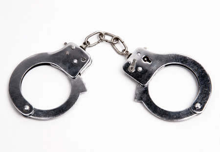 Metal handcuffs on whiteの写真素材