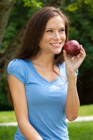 Attractive woman in the park with an Appleの写真素材