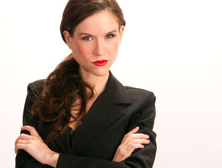 An attractive woman stands arms crossed in her Business Suitの写真素材