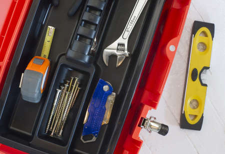 Orange Tool Box with Crescent Measuring Tape Level Boxcutter Screws and Multi Purpose Toolの写真素材