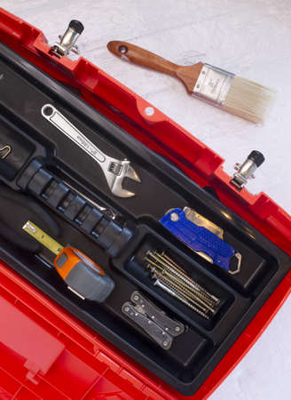 Orange Tool Box with Crescent Tape Brush Boxcutter Screws and Multi Purpose Toolの写真素材