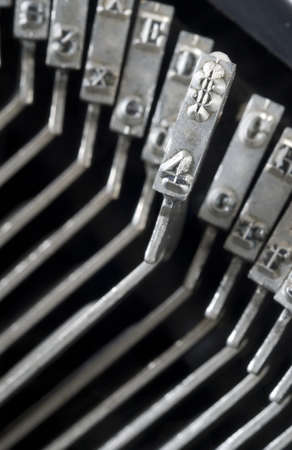 Dollar Sign and the number 4 raised out of Striker Bed in Vinatage Typewriterの写真素材