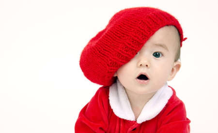 Cute Infant Boy in a horizontal composition crawling in red outfit and hatの写真素材