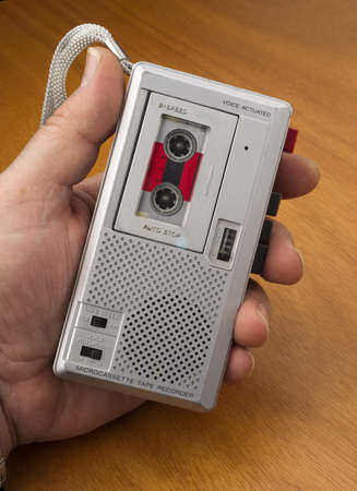 Male Hand Holds Audio Recorder using Tape for documenting soundの写真素材