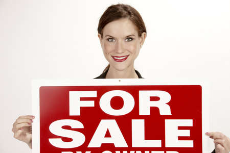 girl hold For Sale by Owner sign boardの写真素材