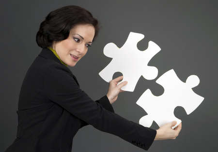 Female holding two large pieces of the puzzleの写真素材