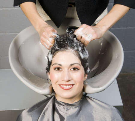 Attractive Woman Gets Spa Salon Shampoo and Conditioningの写真素材