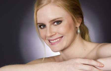 Beautiful Happy Blond Woman Smiling Big in Head and Shoulders Beauty Poseの写真素材
