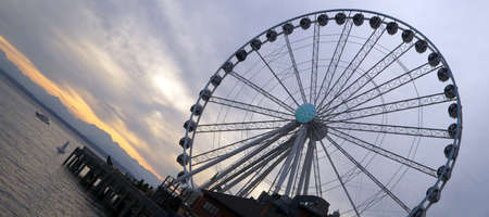 Seattle, Washington, USA - May 10, 2013: One of the biggest Ferris wheels in the United States, The Seattle Great Wheel is operating here as the sun sets over Puget Sound.のeditorial素材