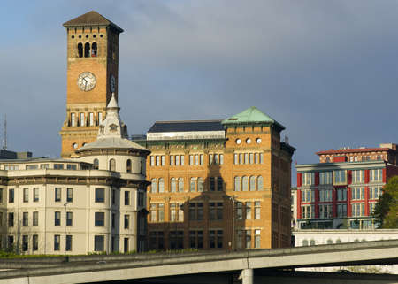 The sun rises hitting the buildings of Downtown Tacoma Washington United Statesの写真素材