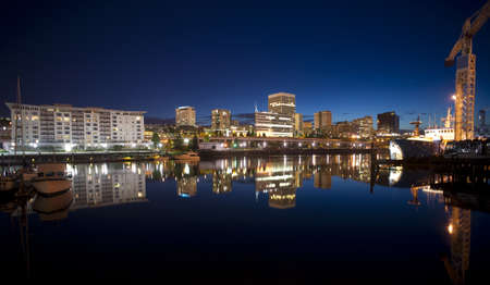 Night falls behind the Tacoma skyline and boats on Thea Foss Waterwayのeditorial素材
