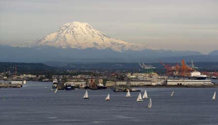 An evening boat race is conducted on the waters of Puget Sound Tacoma Washingtonのeditorial素材