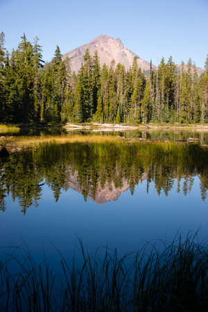 Four Mile Lake shows a nearly perfect reflection for Mt McLoughlinの写真素材
