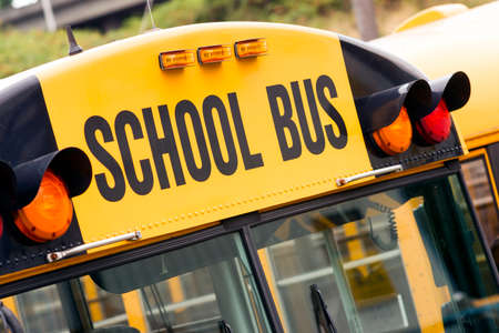 School bus sitting in the parking lot waiting to be in serviceの写真素材