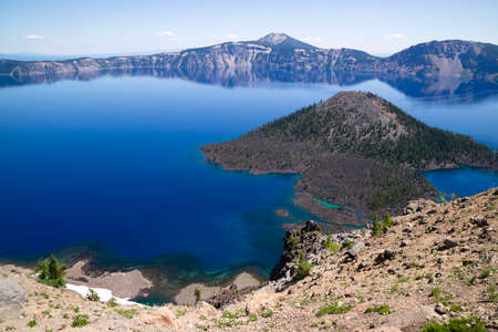 Wizard Island is a volcanic cinder cone which forms an island at the west end of Crater Lakeの写真素材