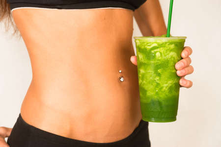 Slender Female Torso Tanned Toned Body Blended Fruit Smoothie Drinkの写真素材